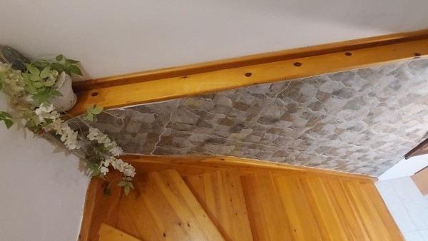 The Cottage has traditional Greek decor with stone and wood.